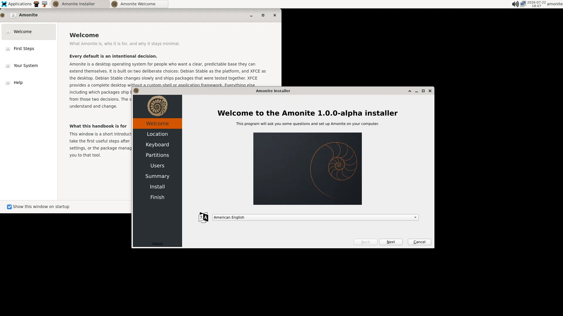 Amonite live session at first boot with the Welcome handbook and installer open on an empty desktop